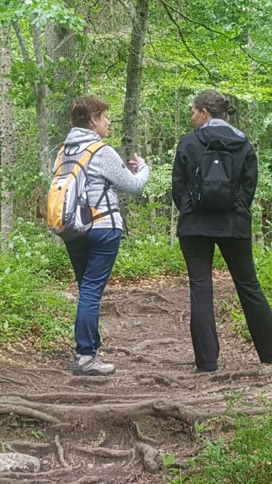 Erika Harding talking with a woman in nature